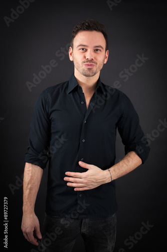 handsome man doing different expressions in different sets of clothes: hungry