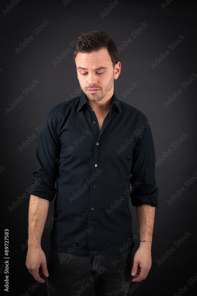 handsome man doing different expressions in different sets of clothes: sad handsome man doing different expressions in different sets of clothes: sad