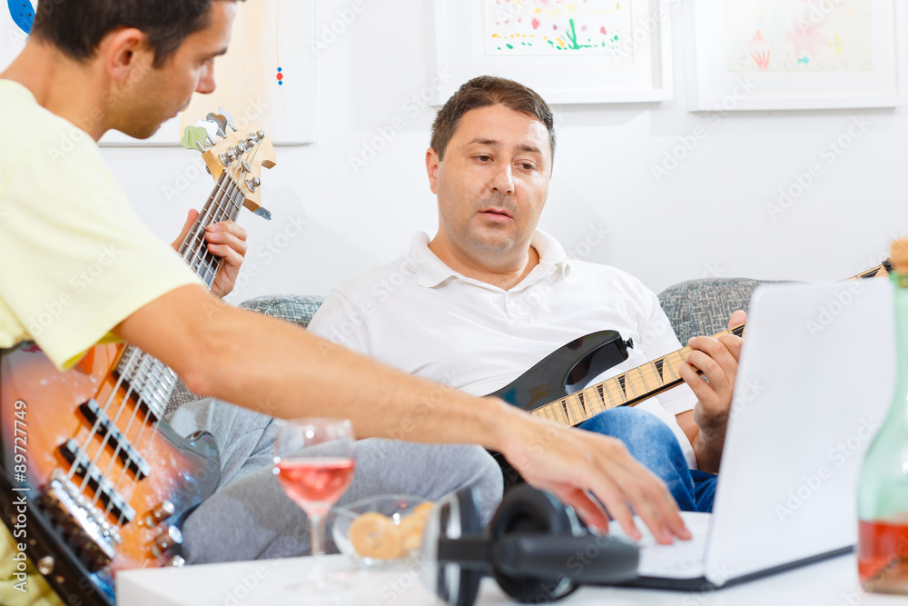 Musicians practicing to a track played on a computer Musicians practicing to a track played on a computer
