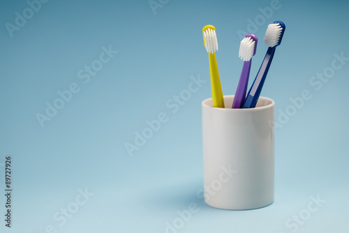 Toothbrushes in a ceramic holder