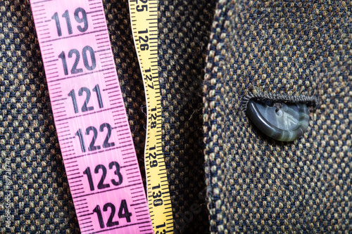 Bild auf Leinwand measuring tapes and half buttoned button on jacket