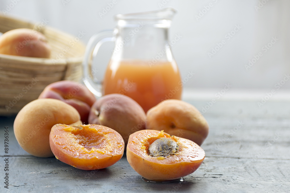 Fresh apricots and juice on light gray wood, copy space in the b Fresh apricots and juice on light gray wood, copy space in the b