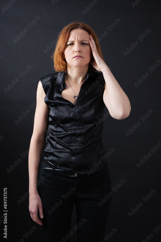 Beautiful woman doing different expressions in different sets of clothes: headache Beautiful woman doing different expressions in different sets of clothes: headache