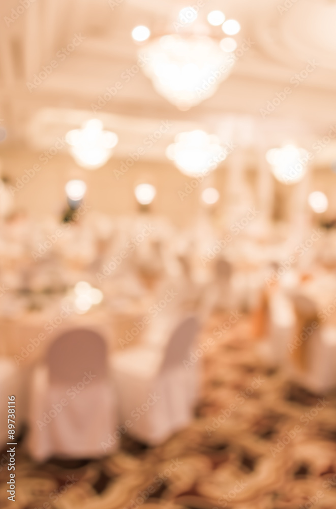 blurred image of Large dining table set for wedding, dinner or f