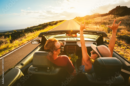 Happy Couple Driving in Convertible photo