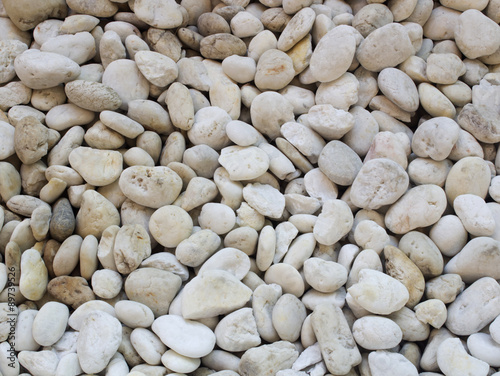 Small naturally polished white rock pebbles background