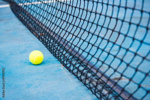 tennis ball on a tennis court with net © Sunanta
