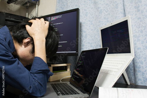 Stressed Asian engineer  put his hands on his head