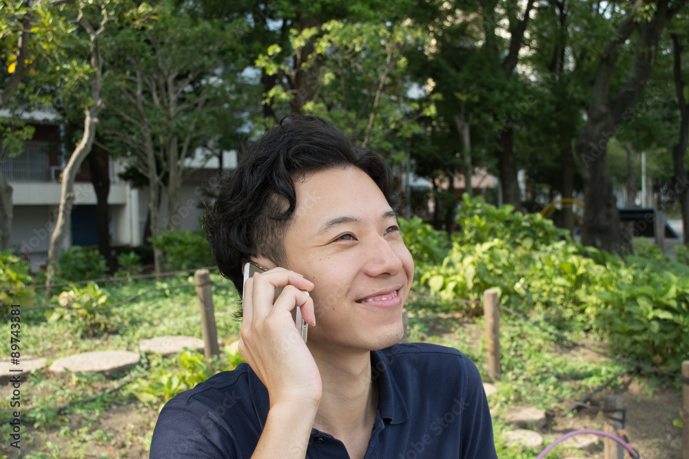 Asian businessman is talking on a smart phone with smile Asian businessman is talking on a smart phone with smile