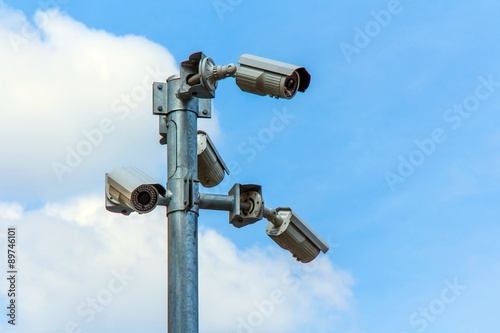 CCTV camera or Surveillance Operaiting on Blue Sky.