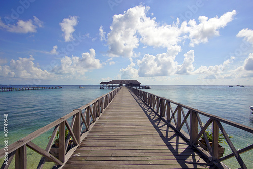 endless jetty to the horizon; view to a turquoise sea and blue s
