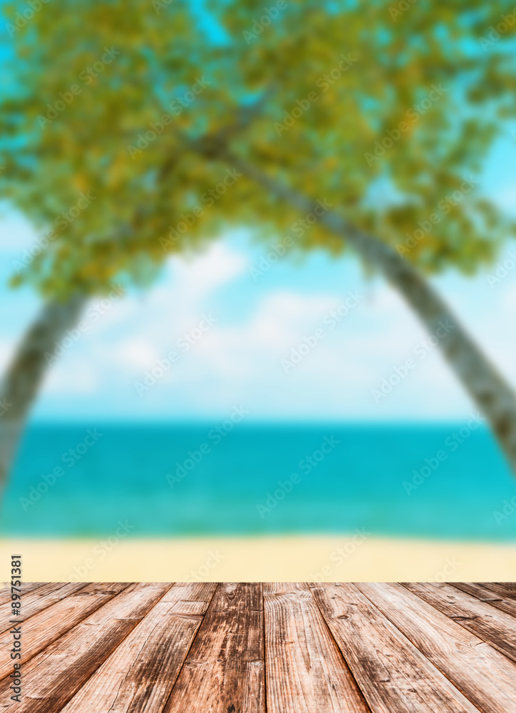 Fototapeta premium Blurred image of sea sky coconut tree with wooden under for put products.