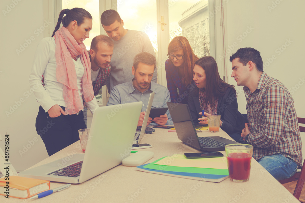 Young group of people discussing business plans. Young group of people discussing business plans.