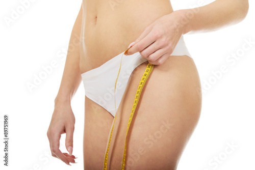 Slim woman with measuring tape.