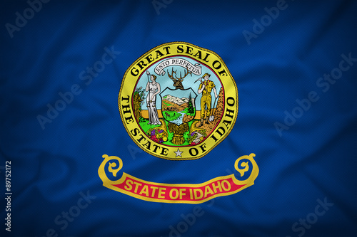 Idaho flag on the fabric texture background,Vintage style