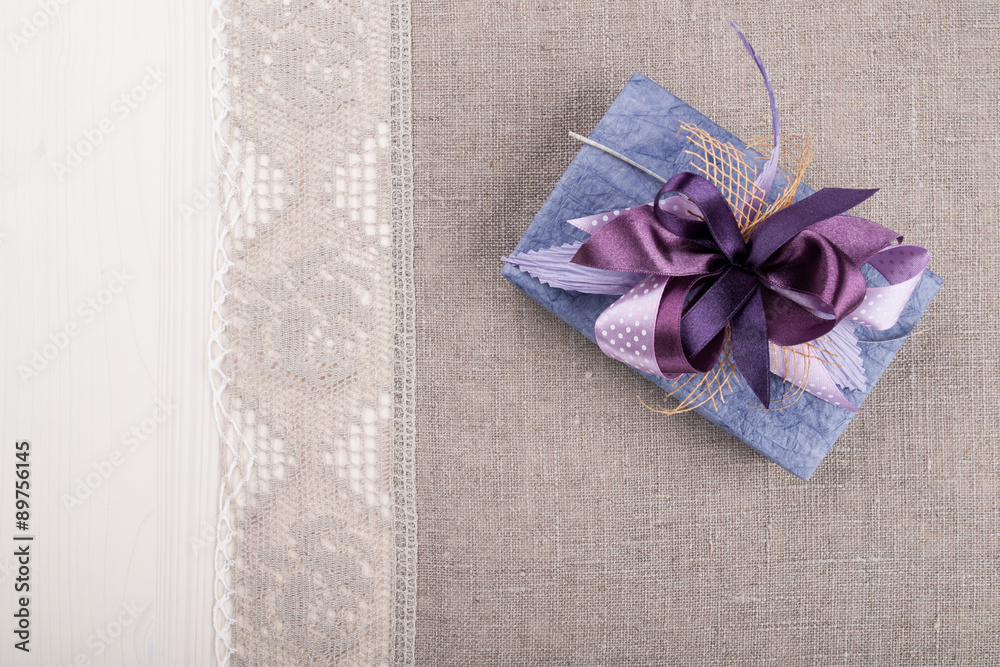 Gift box on linen tablecloth