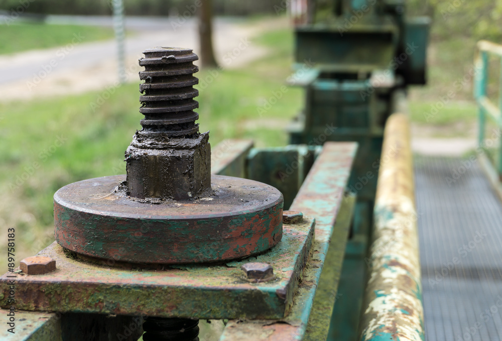 Old big screw and nut - part of the lock mechanism of dam - close-up Old big screw and nut - part of the lock mechanism of dam - close-up