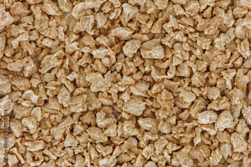 Background of a lot of textured soy protein granules, viewed from above.