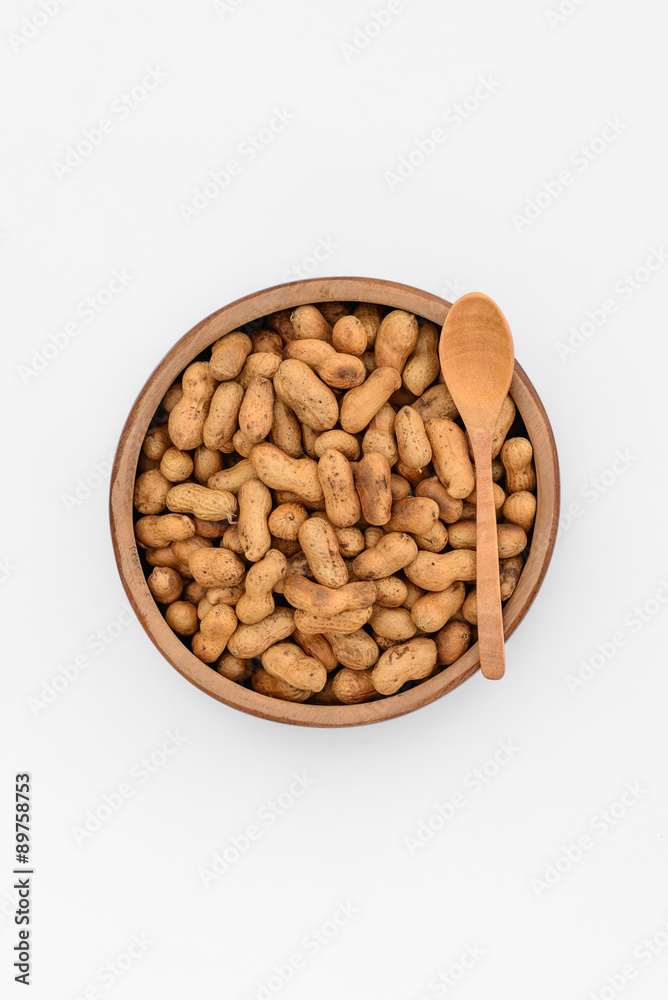 Roasted peanuts in wooden cup, top view isolated on white background. Roasted peanuts in wooden cup, top view isolated on white background.