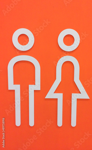White Wooden Man and Woman Restroom Icon on Orange Wall Background