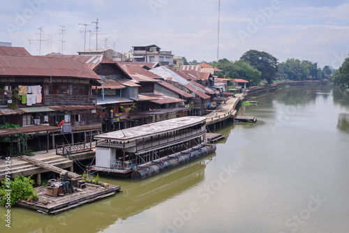 Traditional thai communities and trade boat at pier.