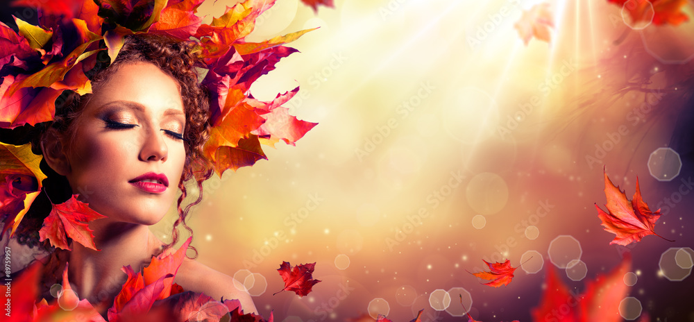 Fototapeta premium Autumn fantasy girl - Beauty fashion model with red leaves and sunlight 