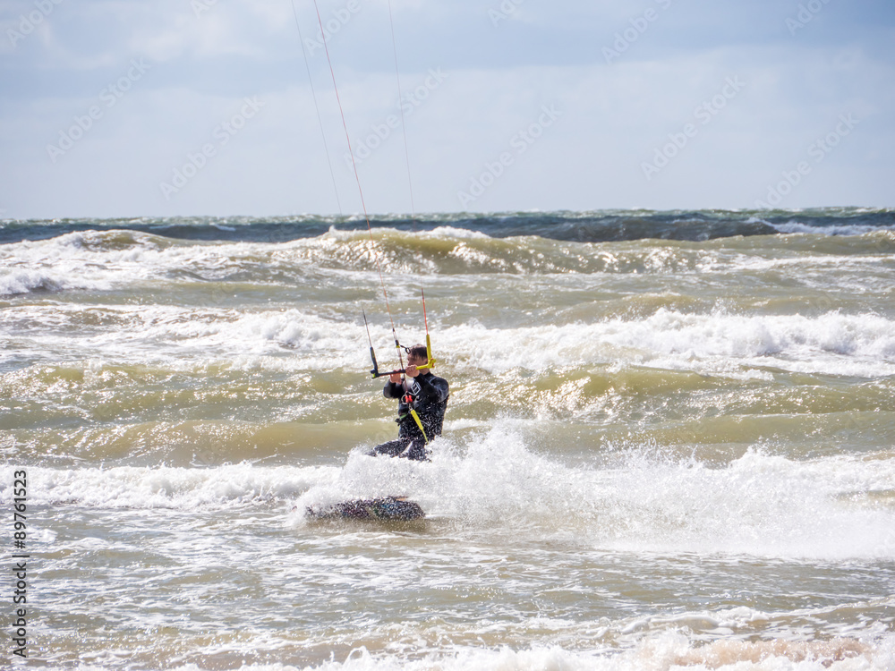 Wakeboarder making tricks on waves
