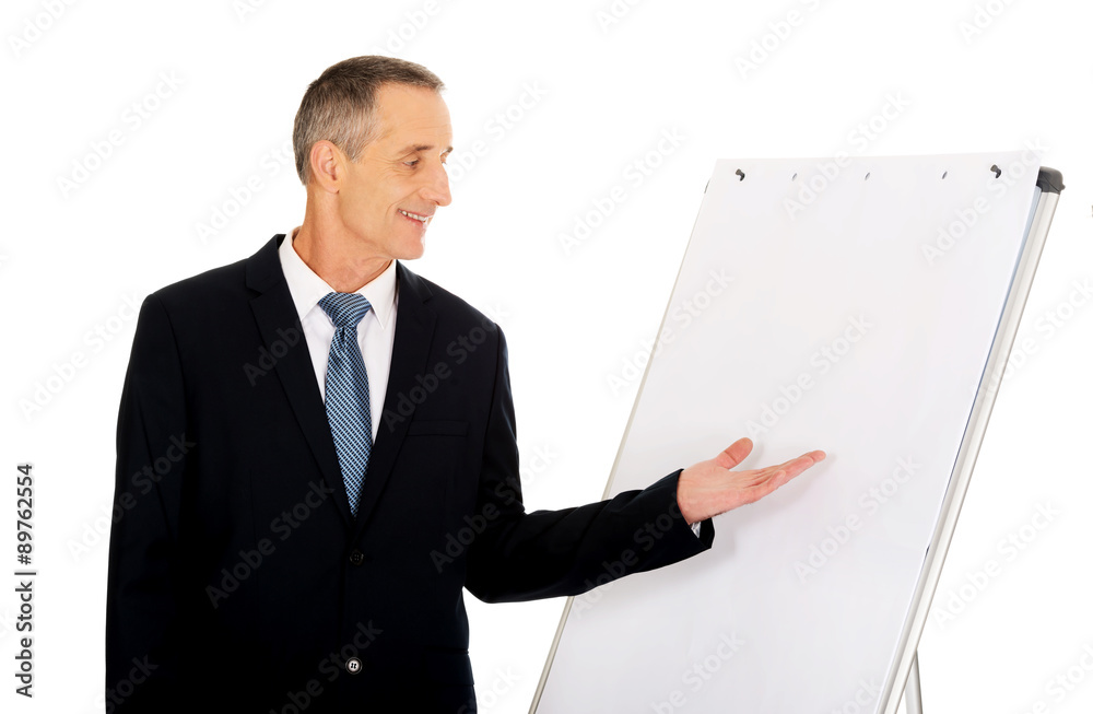 Male executive presenting on flip chart Male executive presenting on flip chart