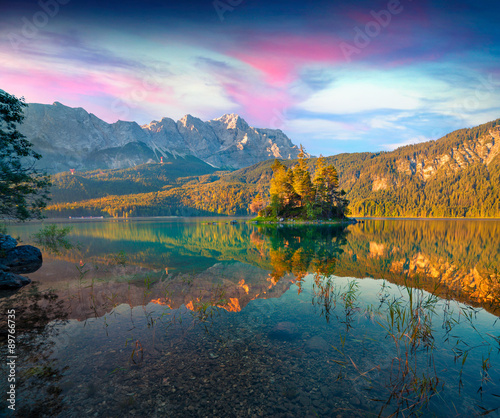 Colorful summer sunrise on the Eibsee lake in German Alps