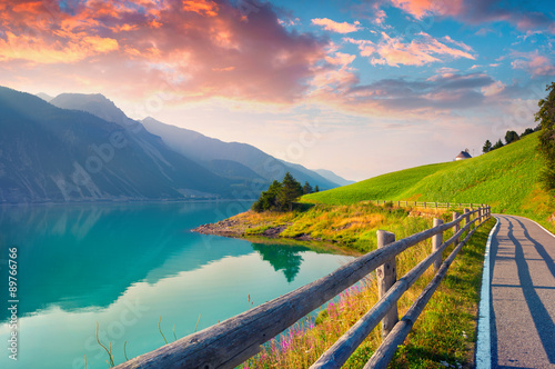 Fototapeta Naklejka Na Ścianę i Meble -  Bicycle path around Resia lake in the Italian Alps.