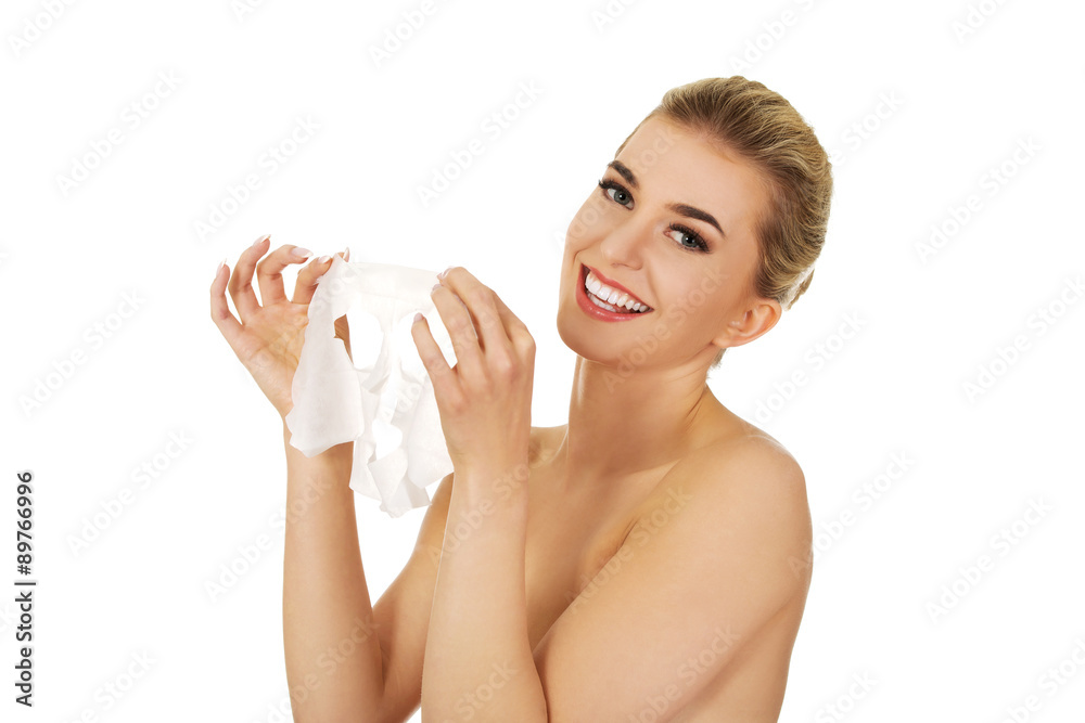 Young happy woman with facial mask