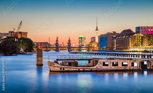 Berlin skyline with old ship wreck in Spree river at dusk, Germany