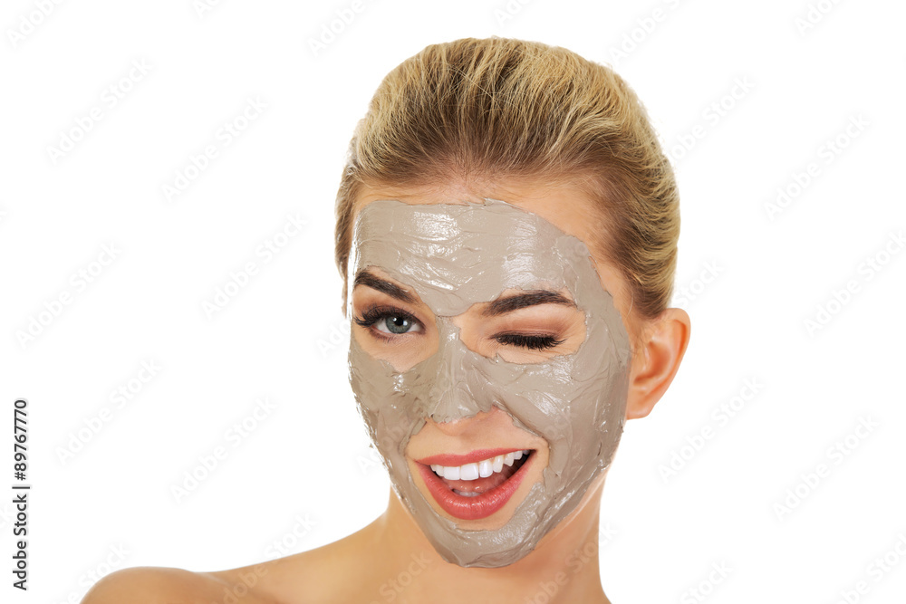 Young happy woman with facial mask. Young happy woman with facial mask.