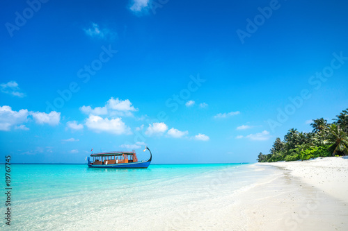 Perfect tropical island paradise beach and boat  Maldives