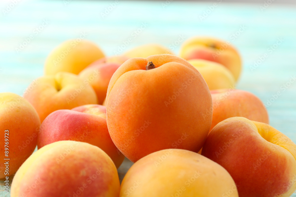 Heap of ripe apricots on wooden table close up Heap of ripe apricots on wooden table close up