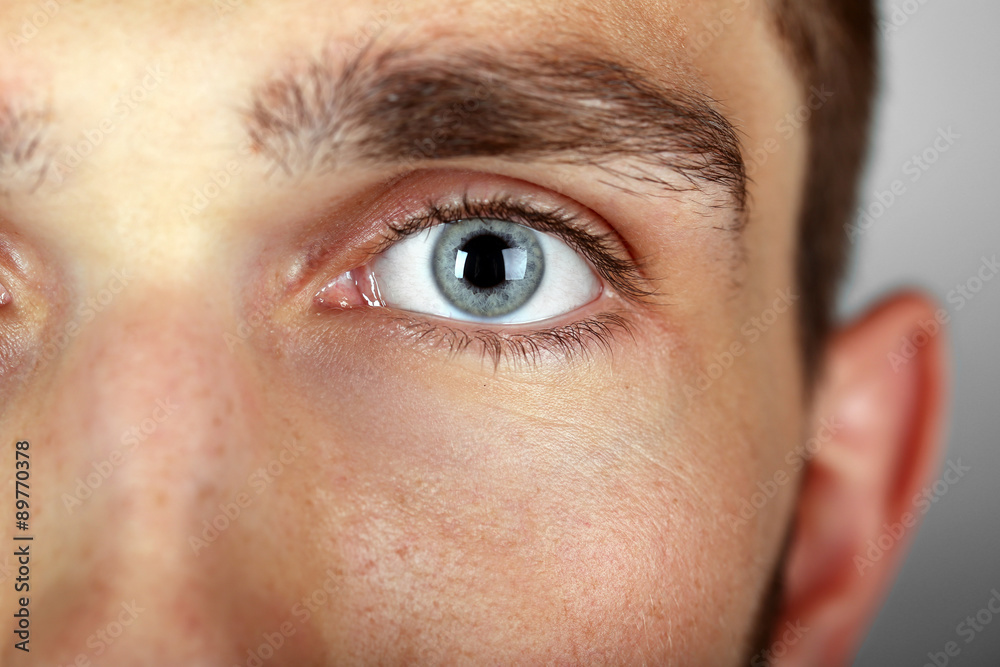 Fototapeta premium Beautiful blue man eye close up