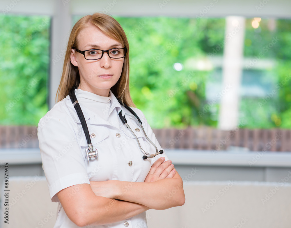 Portrait of a serious female doctor with arms crossed Portrait of a serious female doctor with arms crossed