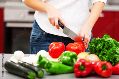 Young woman making salad