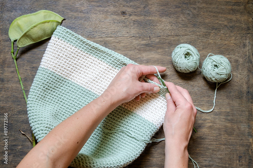 hand knitting crochet bag on a wooden table