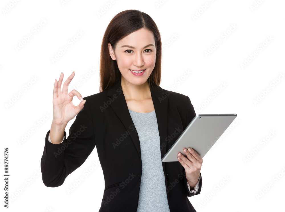 Asian young businesswoman use of the tablet pc with ok sign gest Asian young businesswoman use of the tablet pc with ok sign gest