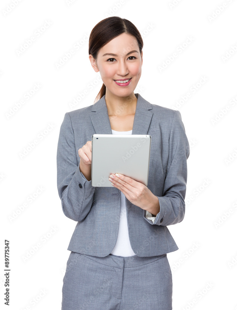 Asian young businesswoman use of the tablet pc Asian young businesswoman use of the tablet pc