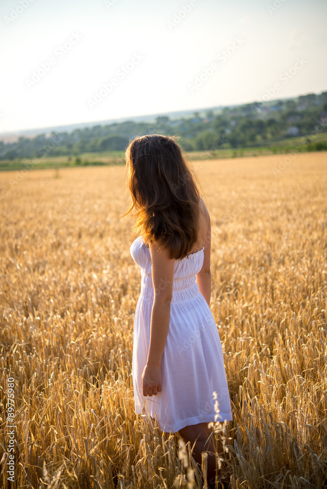 girl in a field looking at sunset girl in a field looking at sunset