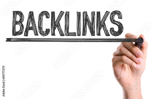 Hand with marker writing the word Backlinks photo