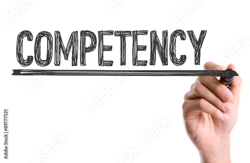 Hand with marker writing the word Competency