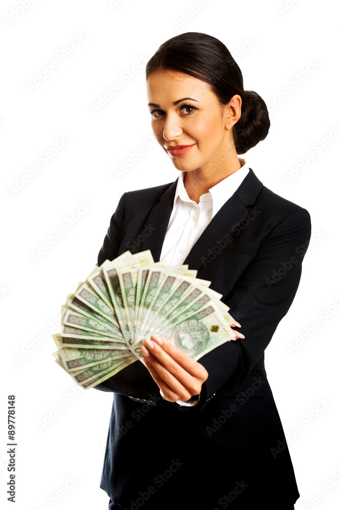 Businesswoman holding a clip of polish money Businesswoman holding a clip of polish money