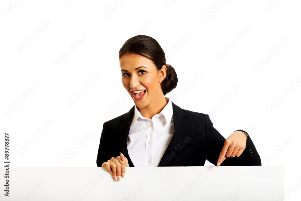 Businesswoman pointing on white banner Businesswoman pointing on white banner
