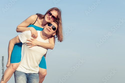 Loving couple standing on the beach at the day time.