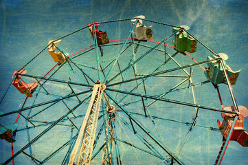 aged and worn vintage photo of ferris wheel