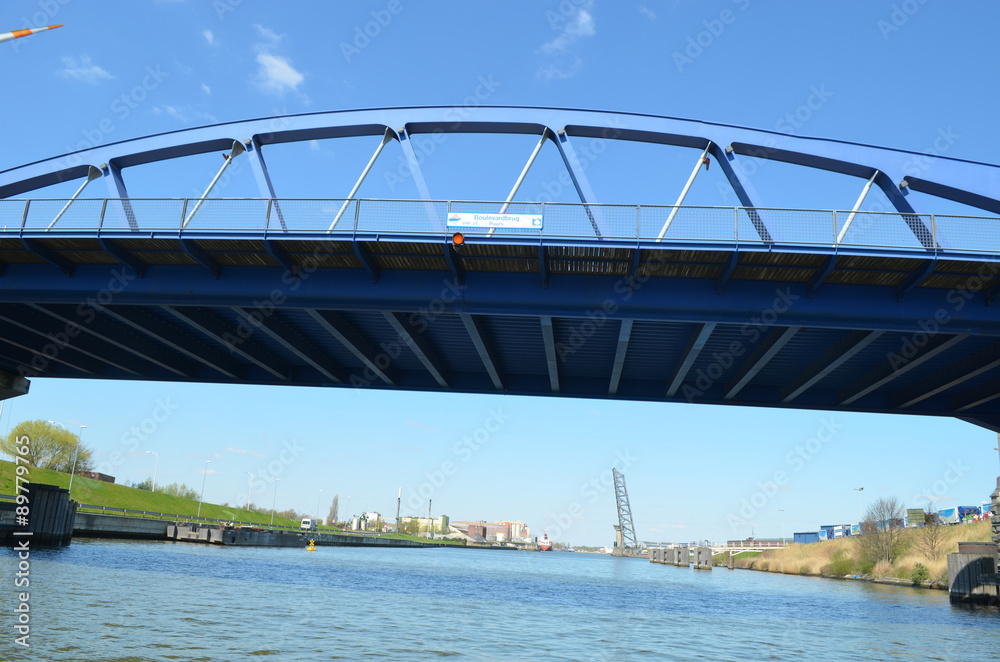 Fototapeta premium blue iron bridge over canal