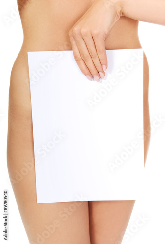 Young naked woman holding empty board